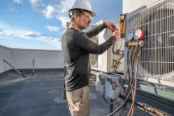 Worker maintaining HVAC unit
